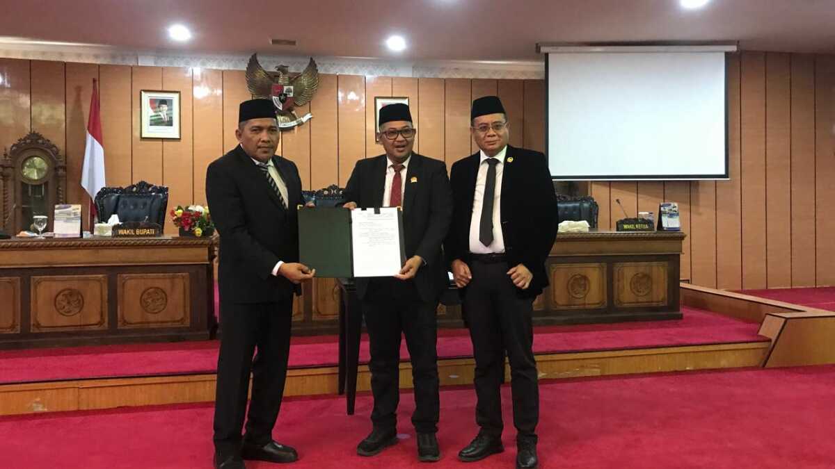 Wakil Bupati Karimun Rocky Marciano Bawole bersama pimpinan DPRD Karimun menunjukkan naskah LKPj Bupati tahun anggaran 2024 dalam rapat paripurna di Ruang Rapat Balai Rong Sri DPRD Kabupaten Karimun, Senin (26/05/2025). (JurnalTerkini.id/edy kencana)