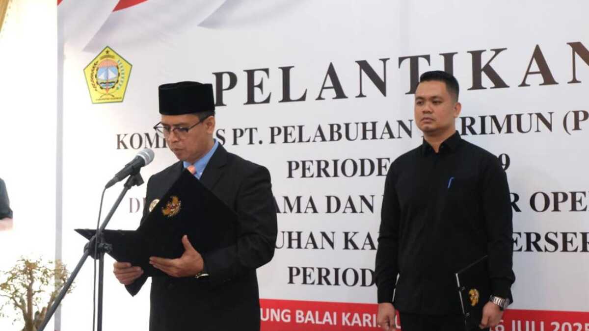 Bupati Karimun Iskandarsyah membaca naskah pelantikan dua direksi dan komisaris PT Pelabuhan Karimun (Perseroda) di rumah dinasnya, Rabu (16/7/2025). (Prokopim Karimun)