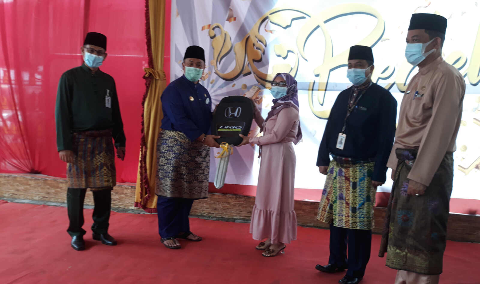 Pjs Bupati Karimun Hery Andrianto didampingi Kepala Bank Riau Kepri Cabang Tanjung Balai Karimun Wan Abdul Rahman dan jajaran menyerahkan secara simbolis kunci mobil Honda Brio, grand prize Sinar Bedelaw dari Bank Riau Kepri. (Foto: rdi)