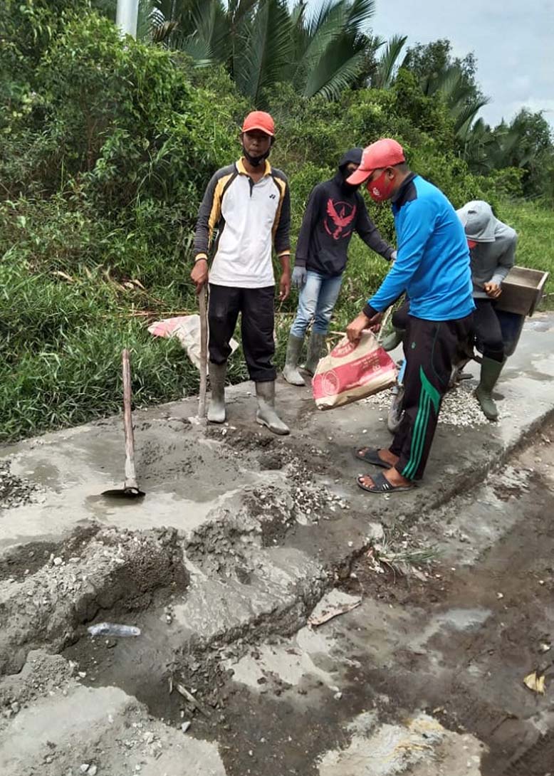 Warga Desa Teluk Nibung swadaya gotong royong memperbaiki jalan poros desa. (foto: abd)