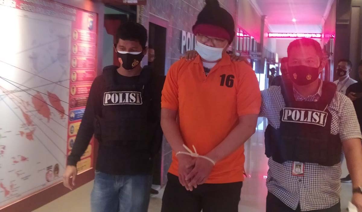 Su alias Along, DPO kasus penganiayaan di parkiran Hotel Wiko digiring polisi setelah ditangkap di Pekanbaru. (foto: yra)