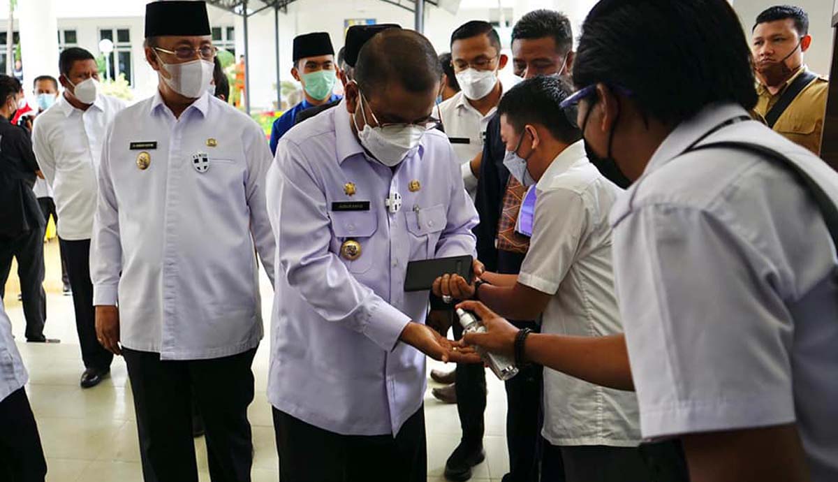 Bupati Karimun Aunur Rafiq, Wakil Bupati Anwar Hasyim dan pejabat lainnya melewati prosedur pemeriksaan suhu tubuh untuk mencegah penyebaran COVID-19 ketika menghadiri musrenbang. (foto: dok. Humas Pemkab Karimun)