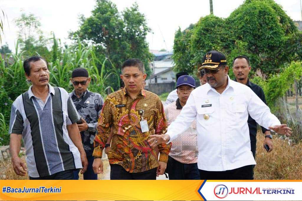 Bupati Karimun Aunur Rafiq didampingi Kepala Dinas PUPR Cahyo Prayitno meninjau saluran yang akan dinormalisasi. (foto: yra)