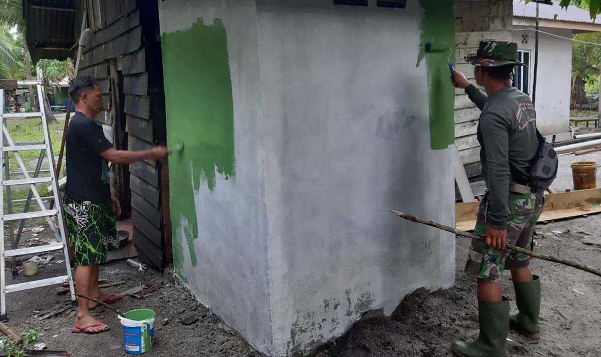 TMMD di Karimun Personel Satgas TMMD ke-114 mengecat jamban yang selesai dibangun di Pulau Parit, Kecamatan Selat Gelam, Kabupaten Karimun, Minggu (14/8/2022). (foto: Dok. Kodim 0317/Karimun)