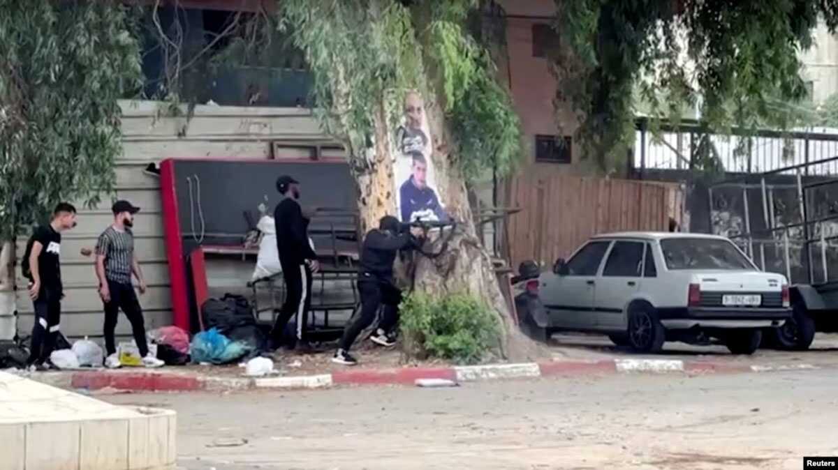 Bentrok palestina israel Seorang pria bersenjata Palestina menembakkan senjata saat bentrokan dengan pasukan Israel dalam penggerebekan di Jenin, di Tepi Barat yang diduduki Israel pada 19 Juni 2023. (REUTERS/Raneen Sawafta-videograb)