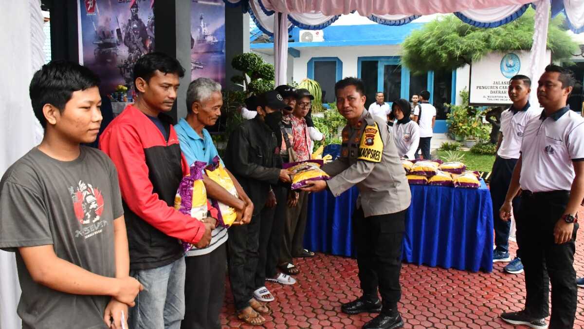 Wakapolres Karimun Kompol Herie Pramono menyerahkan bantuan sembako dalam bakti sosial menyambut HUT TNI ke-78 yang digelar Lanal Tanjung Balai Karimun, Minggu (24/9/2023). (JurnalTerkini.id/Jansen)