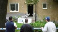 ledakan di swedia Orang-orang mengamati gedung yang ditutup dengan garis polisi menyusul ledakan di Hasselby, Stockholm, Swedia, 26 September 2023. (Fredrik Sandberg/TT News Agency/via REUTERS)
