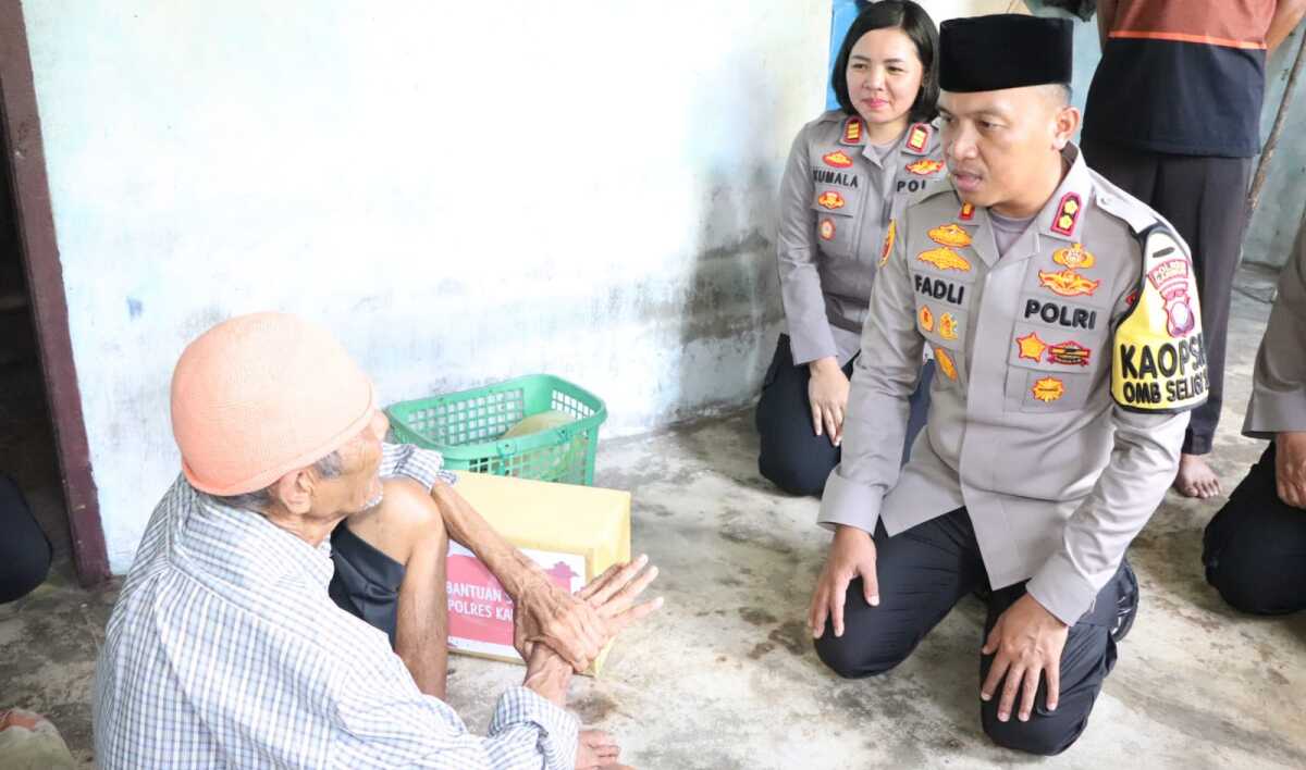 Kapolres Karimun AKBP Fadli Agus menyerahkan bantuan kepada Syahril, warga Parit Benut, Kecamatan Meral, Jumat (10/11/2023). (Dok Humas Polres Karimun)