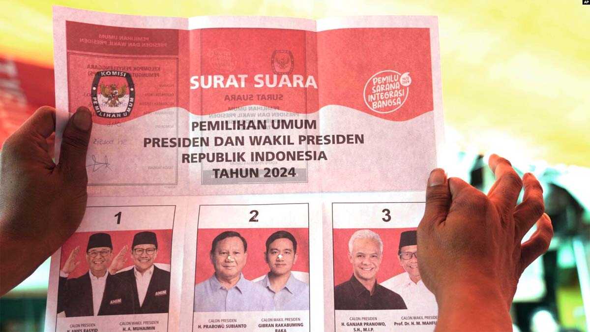 Seorang petugas pemilu memegang surat suara yang menunjukkan suara capres Prabowo Subianto dan pasangannya Gibran Rakabuming Raka, saat penghitungan suara di TPS setelah pemilu di Jakarta, Rabu, 14 Februari 2024. (AP/Tatan Syuflana)