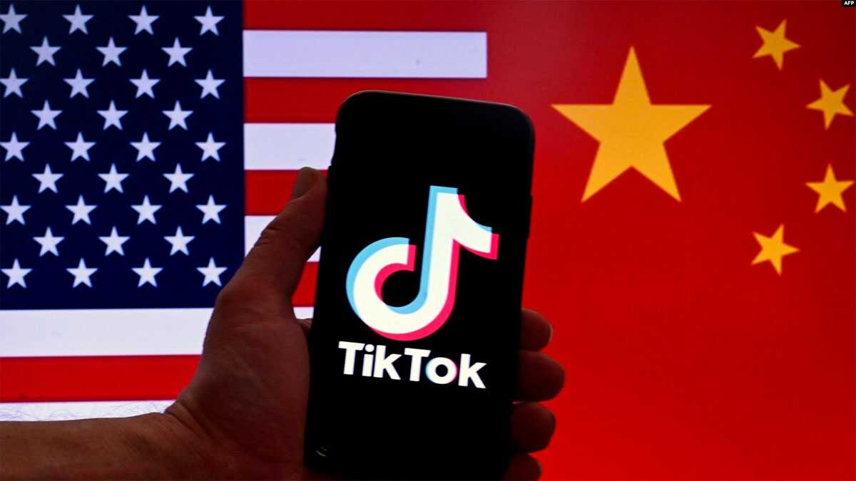 Logo TikTok terpampang di layar iPhone di depan latar bendera AS dan bendera Tiongkok di Washington, DC, pada 16 Maret 2023. (Foto: AFP)