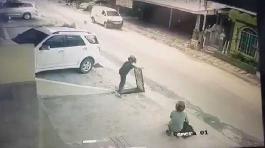 Dua orang mencuri besi penutup drainase atau saluran air di Jalan Pramuka terekam kamera pengawas atau CCTV. (tangkapan layar CCTV)