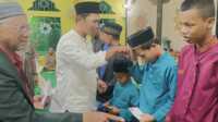 Lurah Harjosari Indra menyerahkan santunan untuk anak yatim dan yatim piatu dalam acara peringatan Isra Miraj Nabi Muhammad SAW di Masjid Al Mujahidin, Kelurahan Harjosari, Kecamatan Tebing, Kabupaten Karimun, Kepulauan Riau, Rabu (29/1/2025) malam. (JurnalTerkini.id/edy kencana)