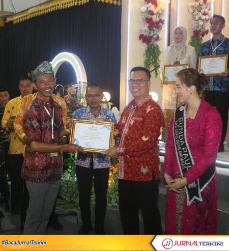 Bupati kepulauan Anambas, Aneng menyerahkan langsung penghargaan Media Terbaik dalam Penyebaran Informasi Pendidikan di Daerah kepada Fendi media JurnalTerkini.id.FOTO:DISKOMINFO